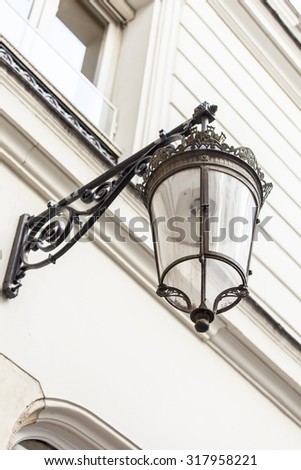 PARIS, FRANCE, on AUGUST 26, 2015. Typical architectural details of historical city building. Old streetlight.