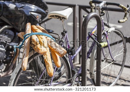PARIS, FRANCE, on AUGUST 26, 2015. French baguettes on a luggage carrier of the old bicycle standing on a parking
