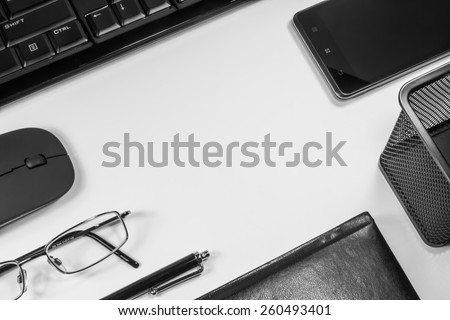 notebook with a pen and a telephone near the computer on a white background