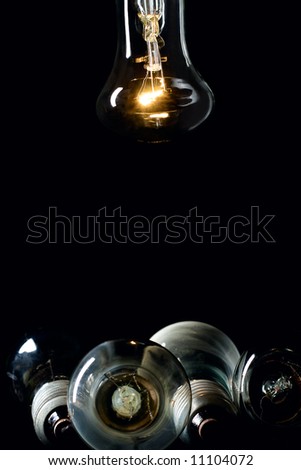 one glow and some broken lamps bulb lamp with dark background