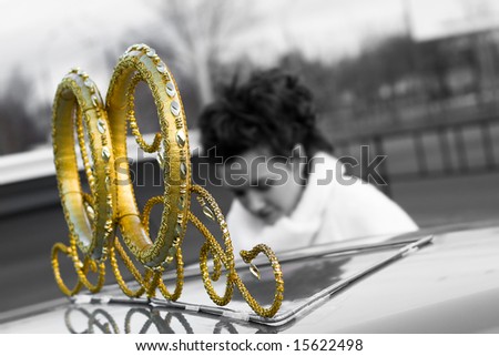 wedding car decoration rings, gray-scale and gold, bride on background plan