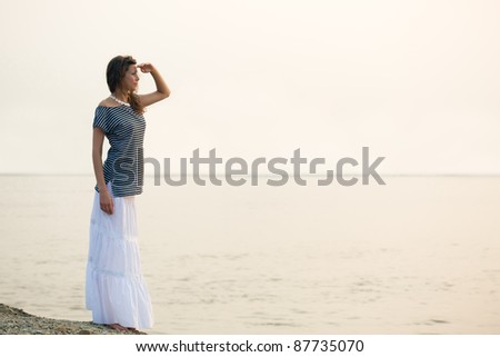 woman standing on coast and looking far away