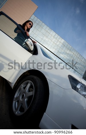 woman standing near car, wide angle view
