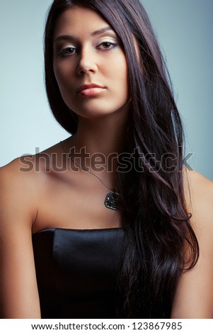 beautiful brunette woman holding  fingers on her neck