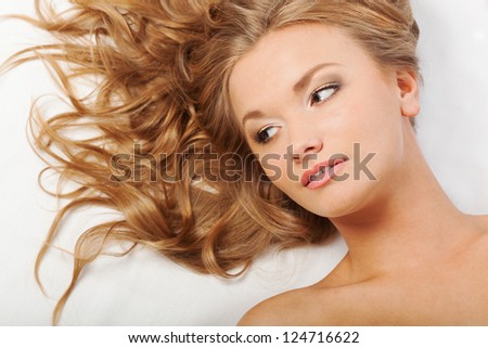 blonde woman with curly hairs laying on the floor