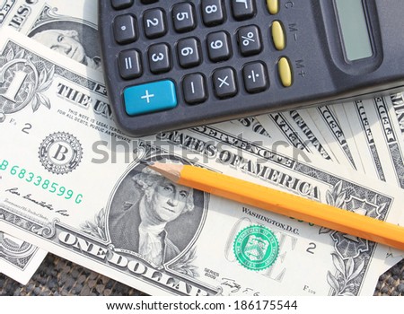 calculator and pencil at dollars