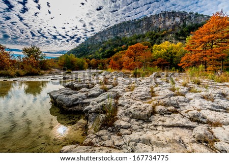 A Texas Hill Country Hill in the Background with Beautiful Fall Foliage Surrounding the Clear Frio River, Texas.