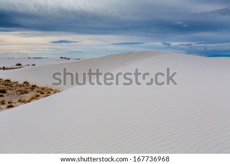 An Interesting View of a White Sand Dune with Clouds at White Sands Monument National Park in New Mexico.