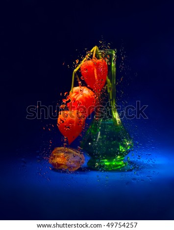 Fantasy with cape gooseberry and wet glass (still life)