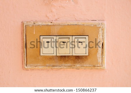 Old switch on pink wall