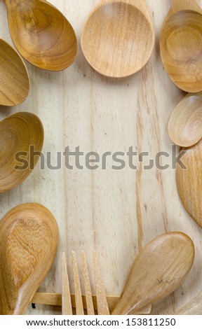 Wood utensils frame on wooden background