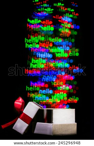 Defocused hello word  lights are moving out of open gift box