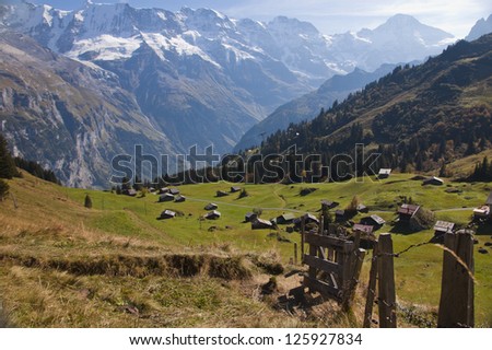 Swiss trail and fence with valley and Alpine mountains