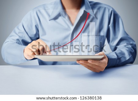 holding touch screen tablet with a graph