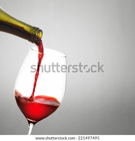 Red wine pouring isolated