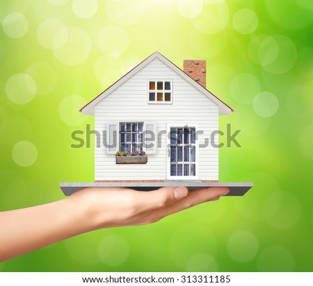 Businessman holding home model, loan concept