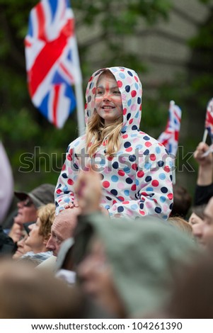 LONDON - JUNE 3: A happy unidentified child with Union Jack face paint lines the River Thames to witness Thames Diamond Jubilee Pageant on June 3, 2012 in London.