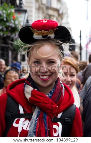 LONDON - JUNE 5: A happy unidentified woman wearing a small crown waits for the carriage procession as part of the Diamond Jubilee celebrations on June 5, 2012 in London.