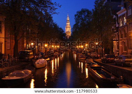 AMSTERDAM - MAY 12 : A church at night along the canal, May 12, 2006, Amsterdam, Holland. Amsterdam\'s name is derived from Amstelredamme indicative of the city\'s origin: a dam in the river Amstel.