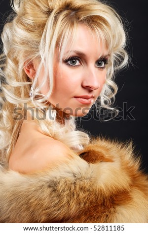 Portrait of a young attractive woman in a fox fur boa.