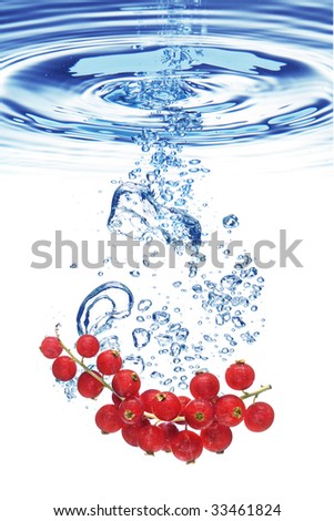 Bubbles forming in blue water after red currant is dropped into it.