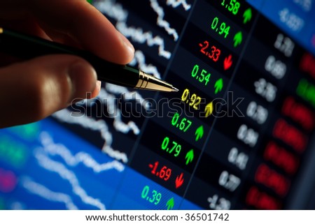chart on computer monitor, market\'s climbing, hand and pen pointer
