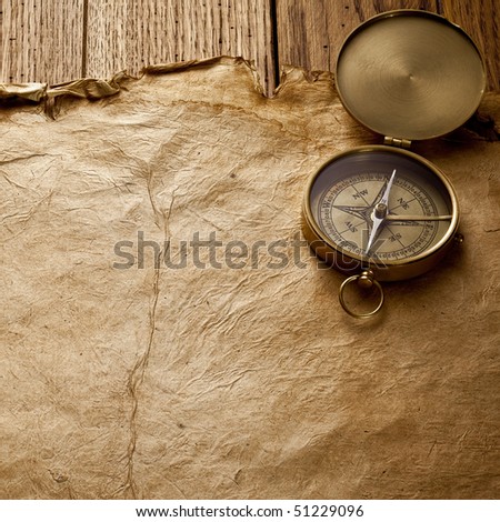 Close up view of the compass on old paper