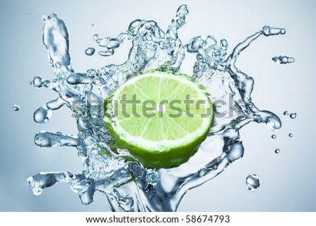 lime in spray of water. lime cucumber with splash on background