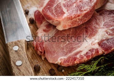 Raw Beef Meat on Wooden Cutting Board Ready for Slice by Steel Knife