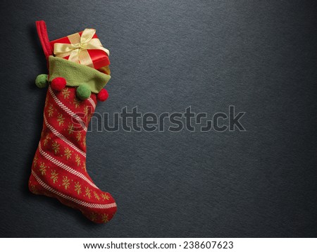 Christmas sock with red gift box on paper background