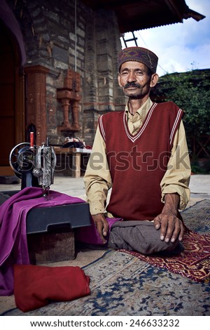 Naggar, INDIA - JULY 17: Traditional Indian tailor. Posing for photography. July 17, 2013 in Naggar, Kullu Valley, Himachal Pradesh, India.