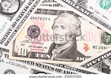 Close-up of ten dollar bill in a dollar stack background