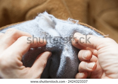 Similar – Image, Stock Photo Darned and sewn up. Torn safety net, which is makeshift patched with string.