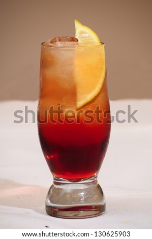 Tequila sunrise Cocktail isolated on a beige background