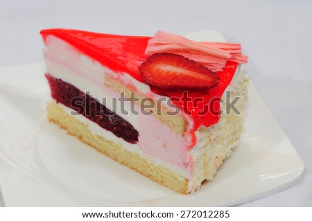 A wedge of strawberry mousse cake