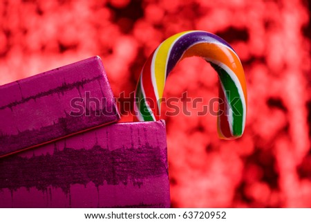 candy canes in gift box on red background