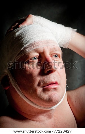 a man bandaged up with a head injury