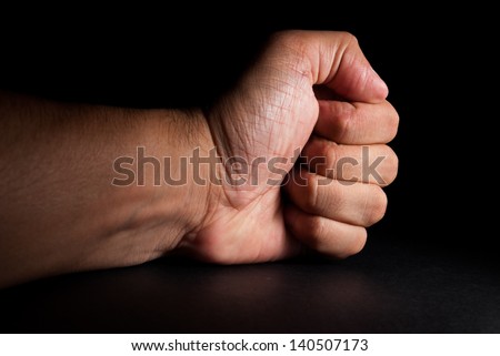 Angry man banging fist on table