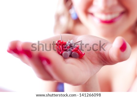 Woman smiling and holding straight pins
