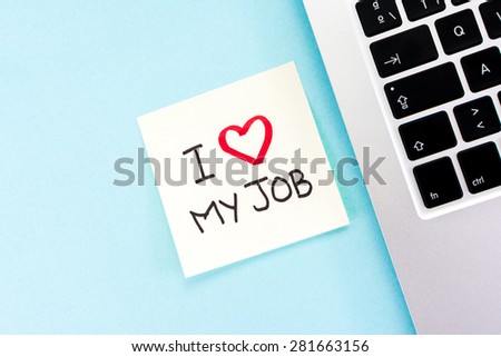 Yellow adhesive note on blue desk with 