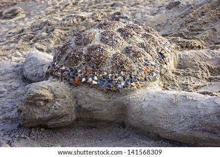 Sea turtle sand sculpture on the beach of Tybee Island, Georgia, USA.