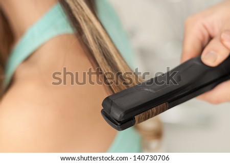 Close of Hair Straightener in action. Shallow DOF.