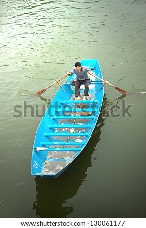HANOI VIETNAM March 2. Man rowing boat. March 2, 2013 in Hanoi, Vietnam. Boat is a common means of transport in Vietnam