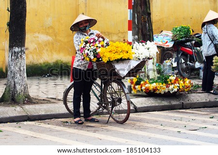 NAMDINH, VIETNAM - March 31: Unidentified small flower vendor at the flower market on March 31, 2014 in Namdinh, Vietnam. This is a small market for retail Florists and street vendors.