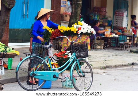 NAMDINH, VIETNAM - March 31: Unidentified small flower vendor at the flower market on March 31, 2014 in Namdinh, Vietnam. This is a small market for retail Florists and street vendors.