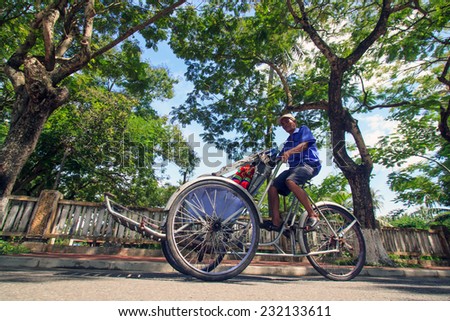 HUE, VIETNAM AUGUST 16, 2013: Cyclo in Hue, vietnam. Cyclo is the tourist\'s farvourite vehicle transportation in Vietnam