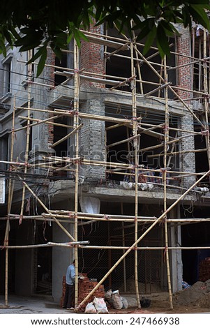 NAMDINH, VIETNAM January 03, 2015: workers doing construction with bamboo scaffolding. Bamboo is easy to find materials in Vienam.