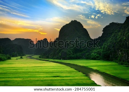 Landscape Vietnam. mountain shadow, field and river in the dim light of dusk at Ninhbinh, Vietnam.