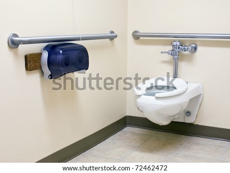 handicap bathroom with grab bars on the walls