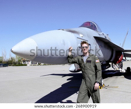 United States Fighter Pilot in full flight gear standing at the front of his jet